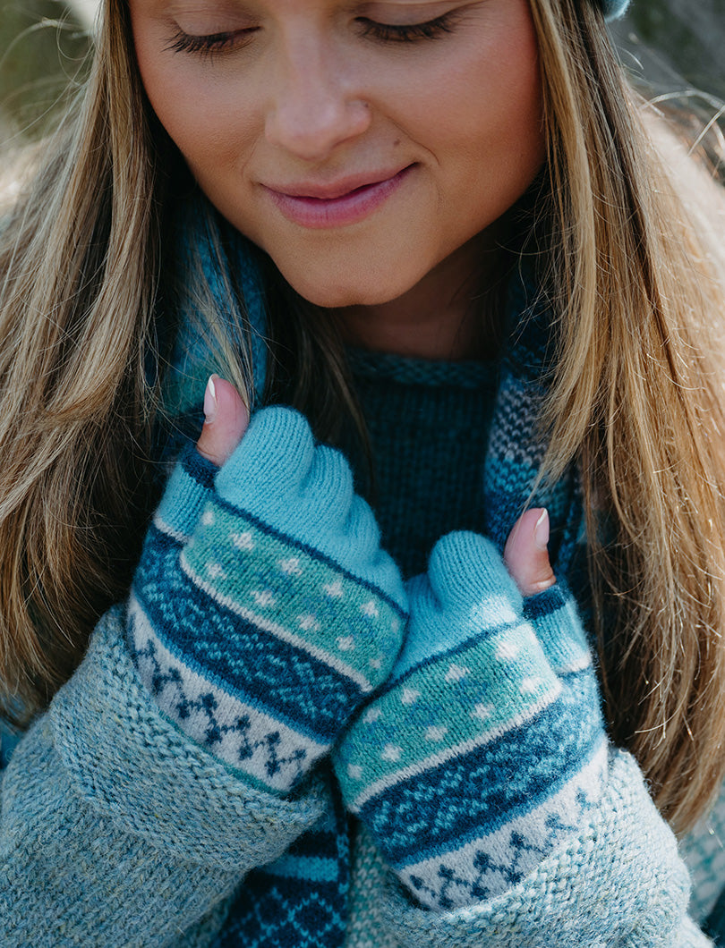 Girl wearing turquoise fair isle fingerless gloves